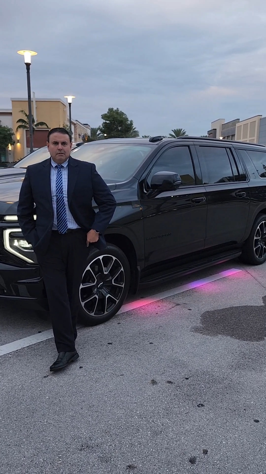 Luis in suit with Suburban